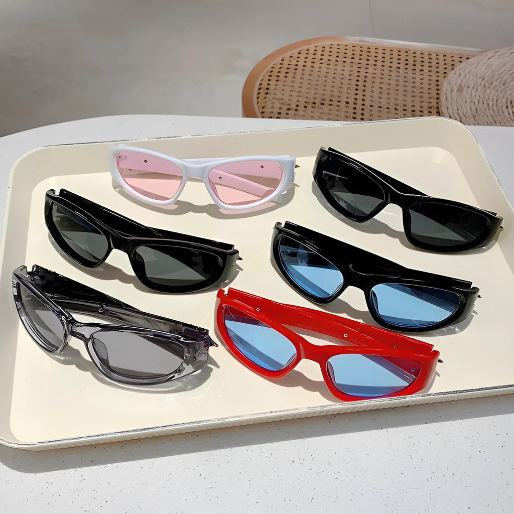 Black frame sports sunglasses with blue polycarbonate lenses on a wooden surface.
