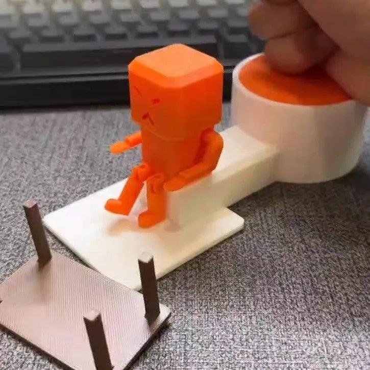 Orange plastic vent decompression artefact, a table turning fidget toy measuring 16x6x7 cm.
