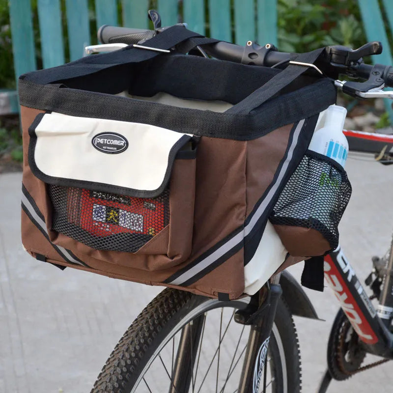 Pet bicycle carrier in Oxford material for small cats and dogs, attached to handlebars with traction hook visible