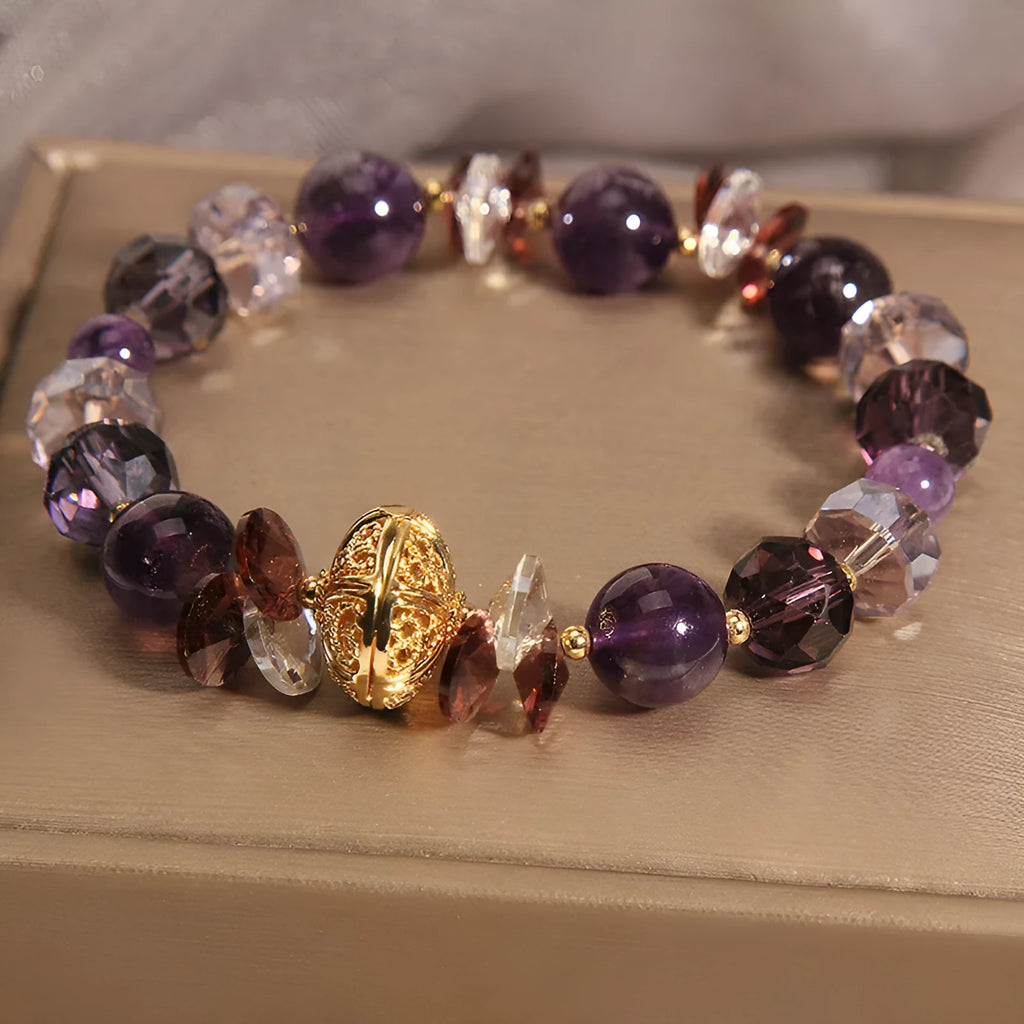 Purple crystal bracelet with pumpkin-shaped beads and rhinestone accents on a wrist.