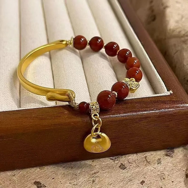 Golden south red agate character ingot bracelet handmade from glass and coloured glaze