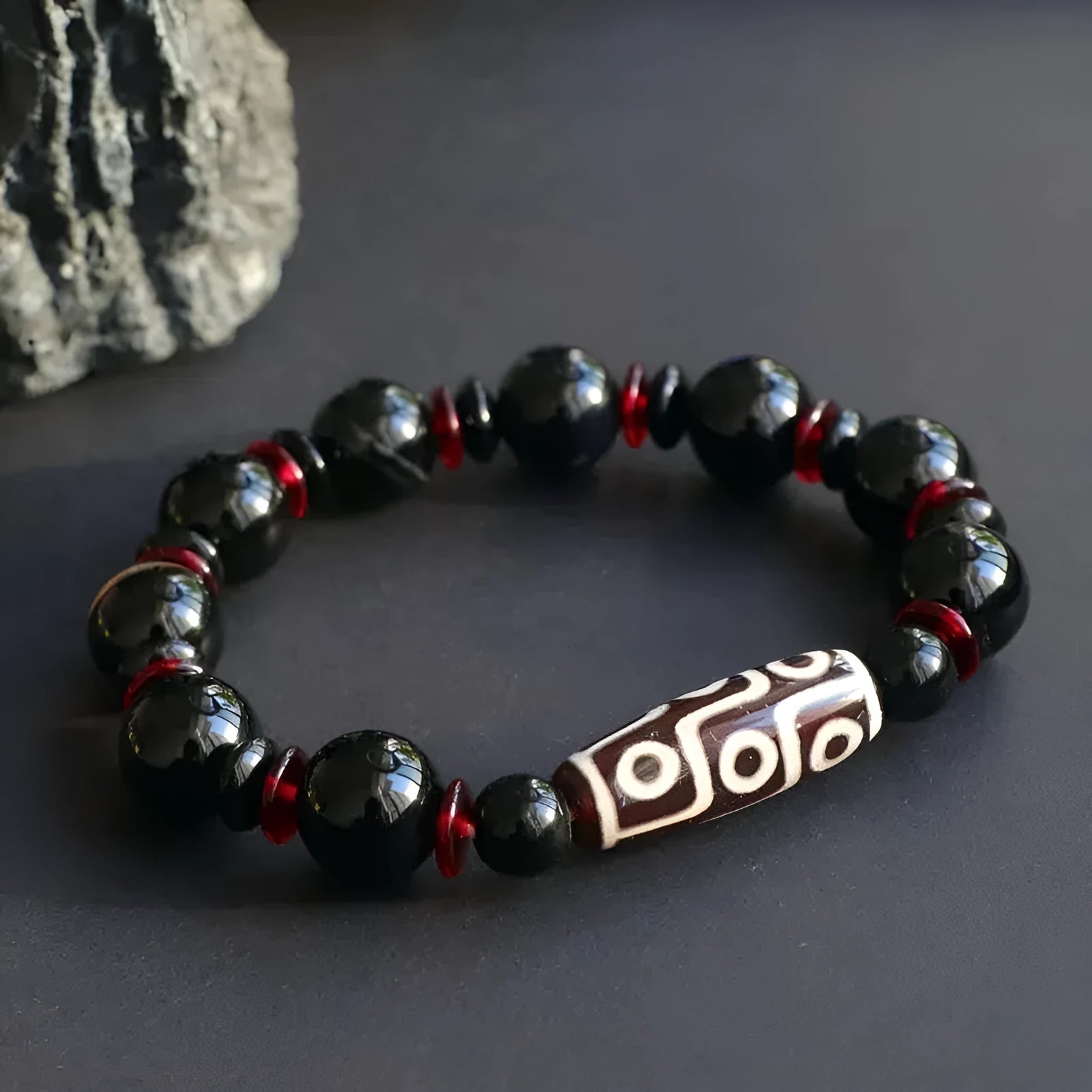 Black agate Dzi bead bracelet with hand-woven construction and 11mm geometric beads