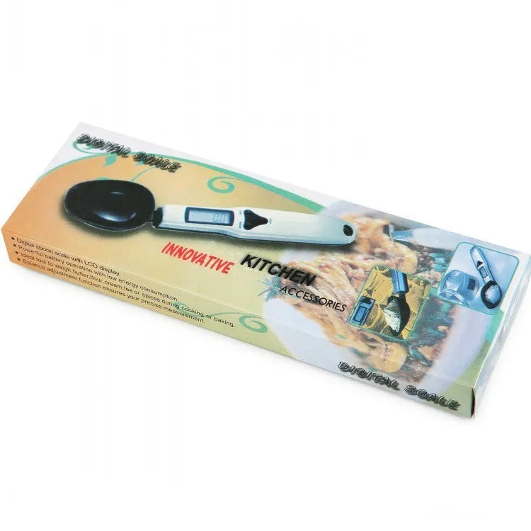 Digital smart measuring spoon with electronic display showing weight, placed on a kitchen worktop.