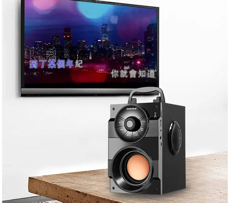 Black portable mini home audio system with subwoofer, cable, and USB power connection.