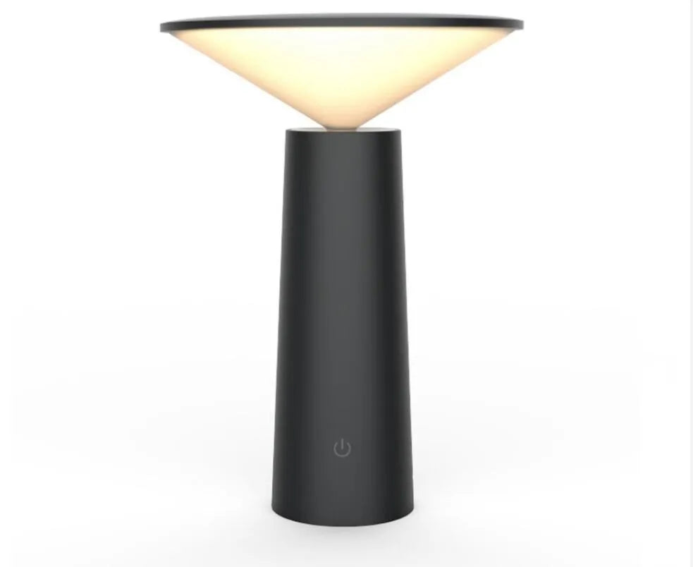 Black USB rechargeable desk lamp with touch sensor base and a tilted lamp head on a wooden desk.