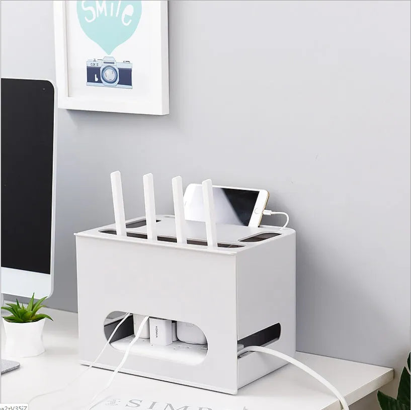 Grey and white plastic wireless router storage box with cable management holes and storage compartments