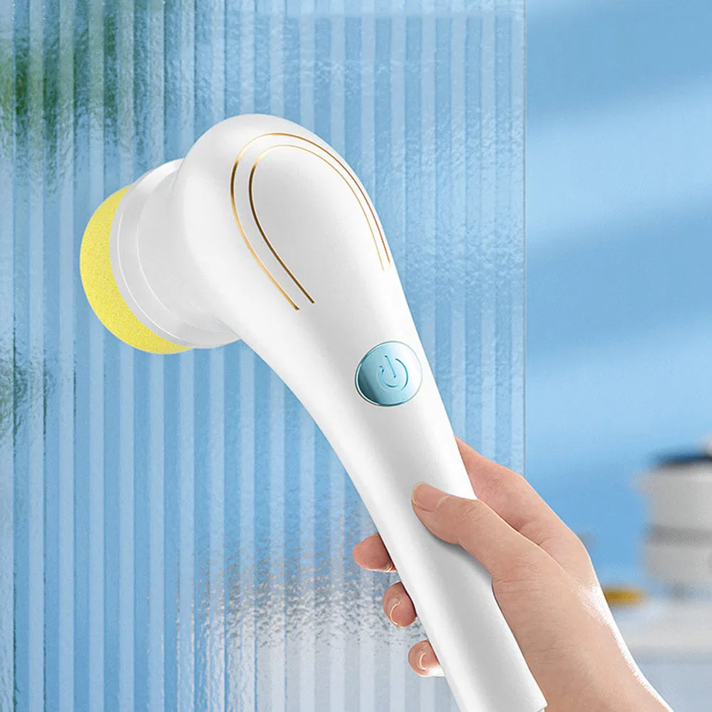 White USB rechargeable cordless electric cleaning brush with five different brush heads on a table.