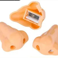 Flesh-coloured plastic student pencil sharpener with geometry design on a white background.