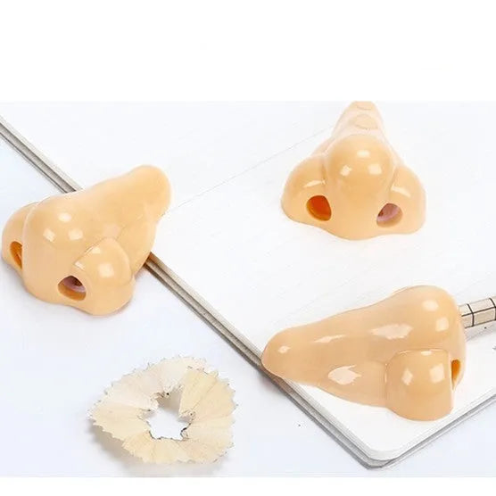 Flesh-coloured plastic student pencil sharpener with geometry design on a white background.