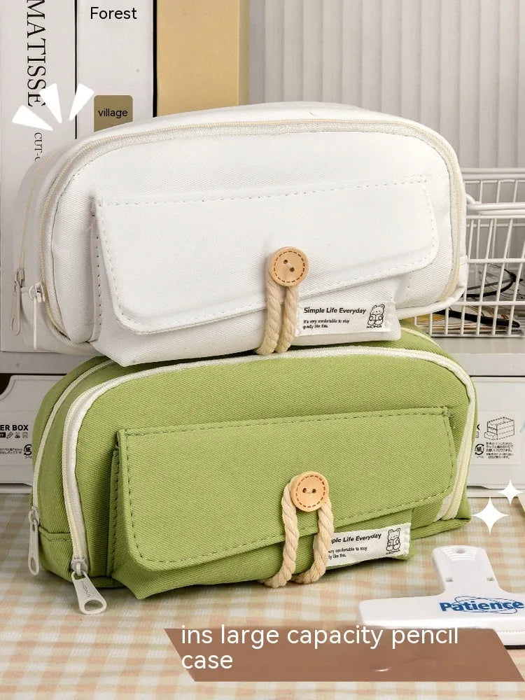 Green canvas pencil case with button closure, large capacity for pens.