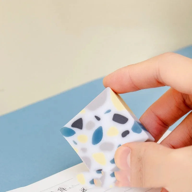 A brick-shaped, single-piece rubber eraser for traceless pencil and charcoal mark removal