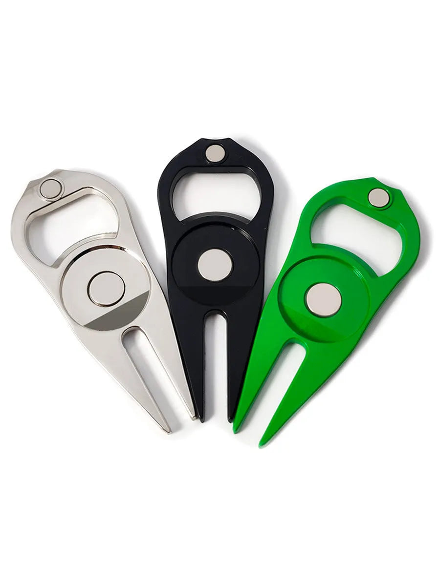 Zinc alloy golf multi-tool with ball yoke, bottle opener, and fork end on a green background.