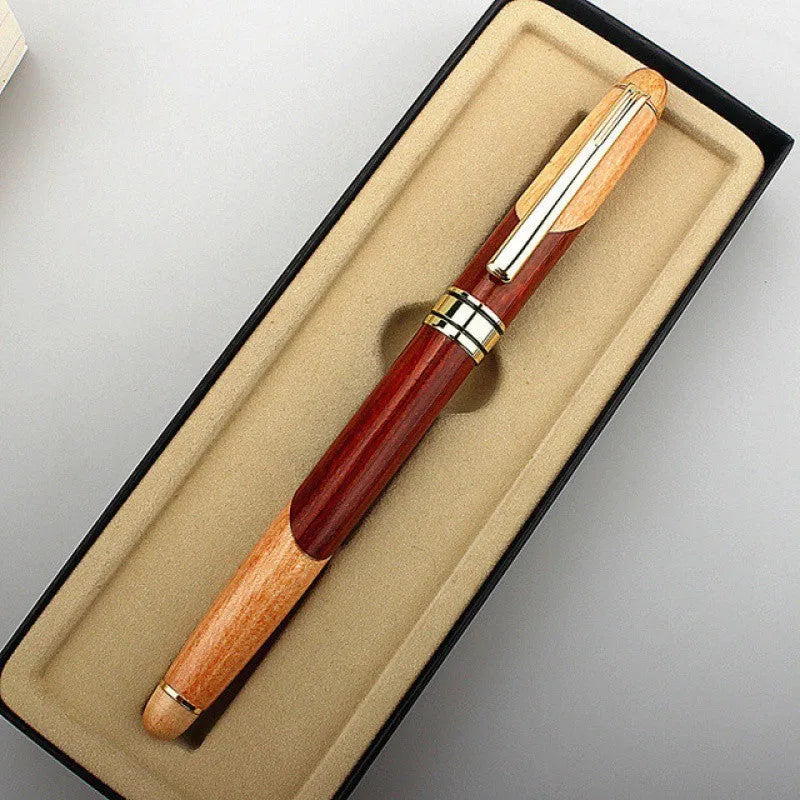 Wooden fountain pen with a metal clip next to a fabric pen bag on a desk.