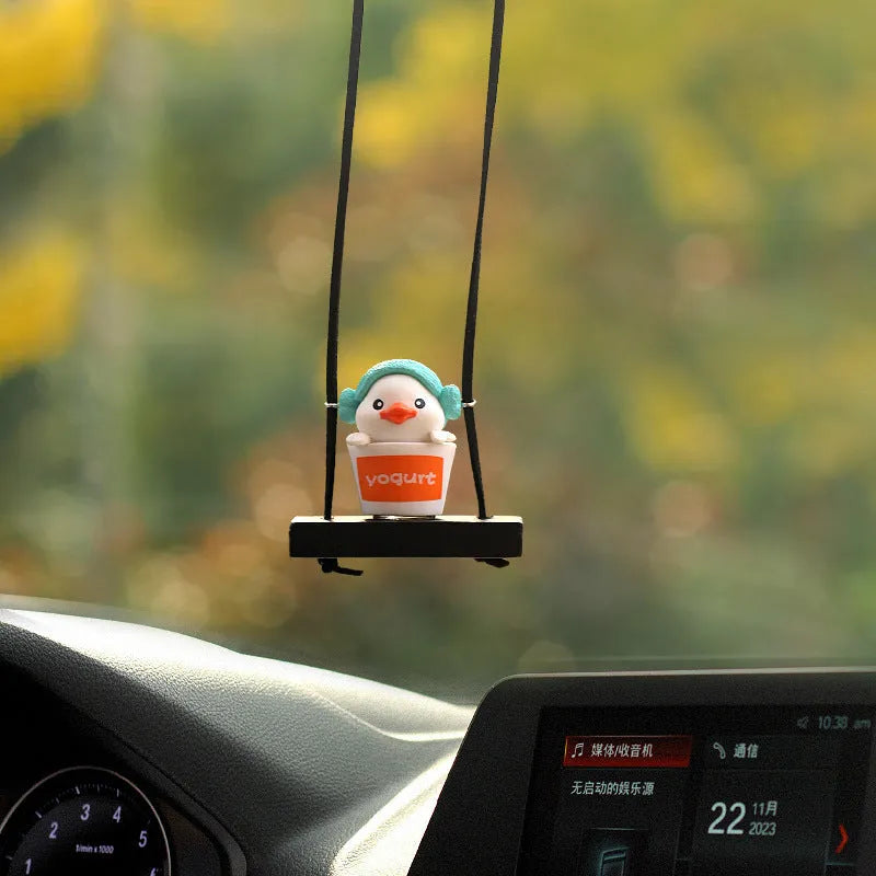 Yellow plastic duck car hanging ornament in cartoon style, shown in four design variants.