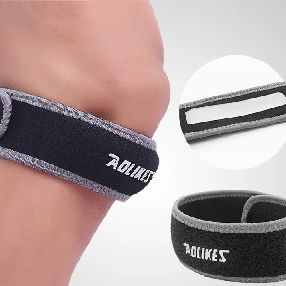 Black and grey patella retinaculum knee pad for sports protection.