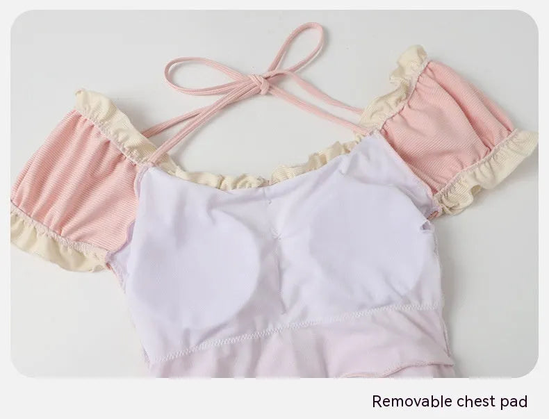 Women's pink conservative one-piece swimsuit with cute Siamese style design