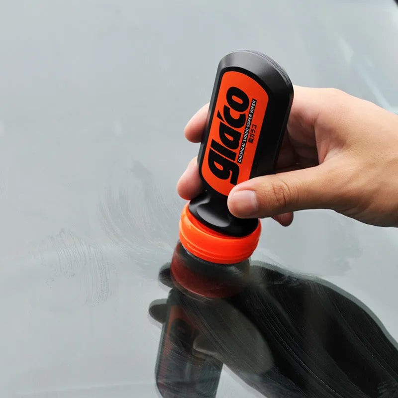 70ml bottle of transparent car glass rain repellent liquid with water beading on a windscreen.
