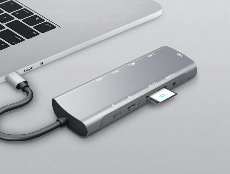 Grey aluminium USB-C docking station with 4K HDMI, VGA, and USB ports, showing 140mm attached cable.