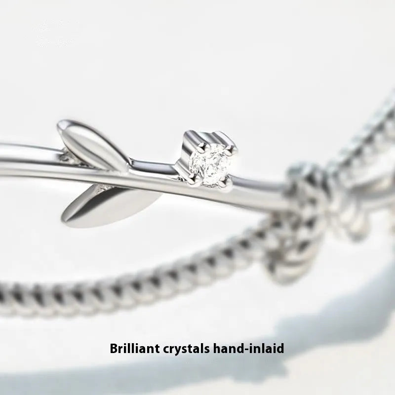 Cross twisted design branch sprout bracelet with white gold electroplated finish on copper