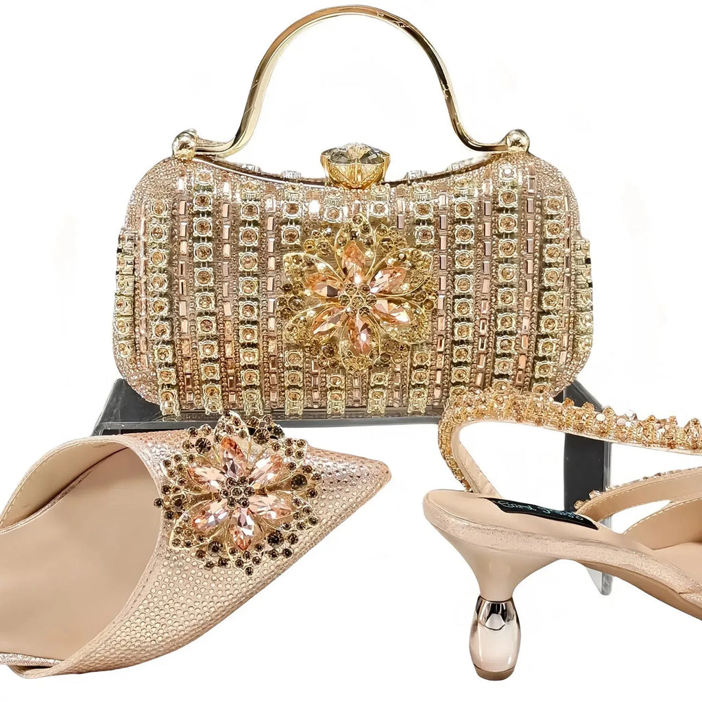 Women's black high-heel ankle boots with chain buckle flower decoration and a matching hard clutch bag.