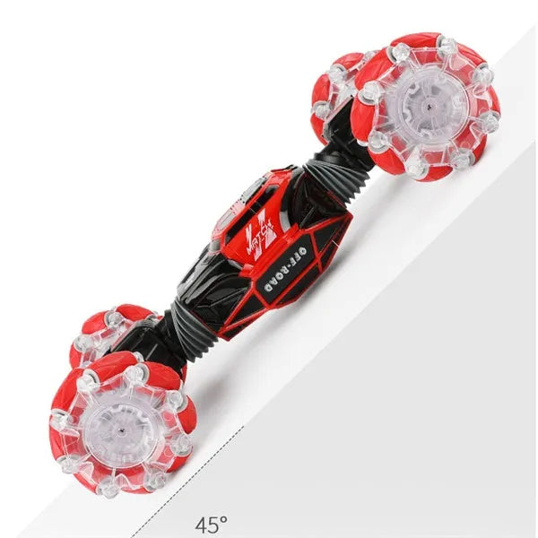 4WD RC stunt car with gesture remote control in red colour on white background showing off-road wheels and LED lights