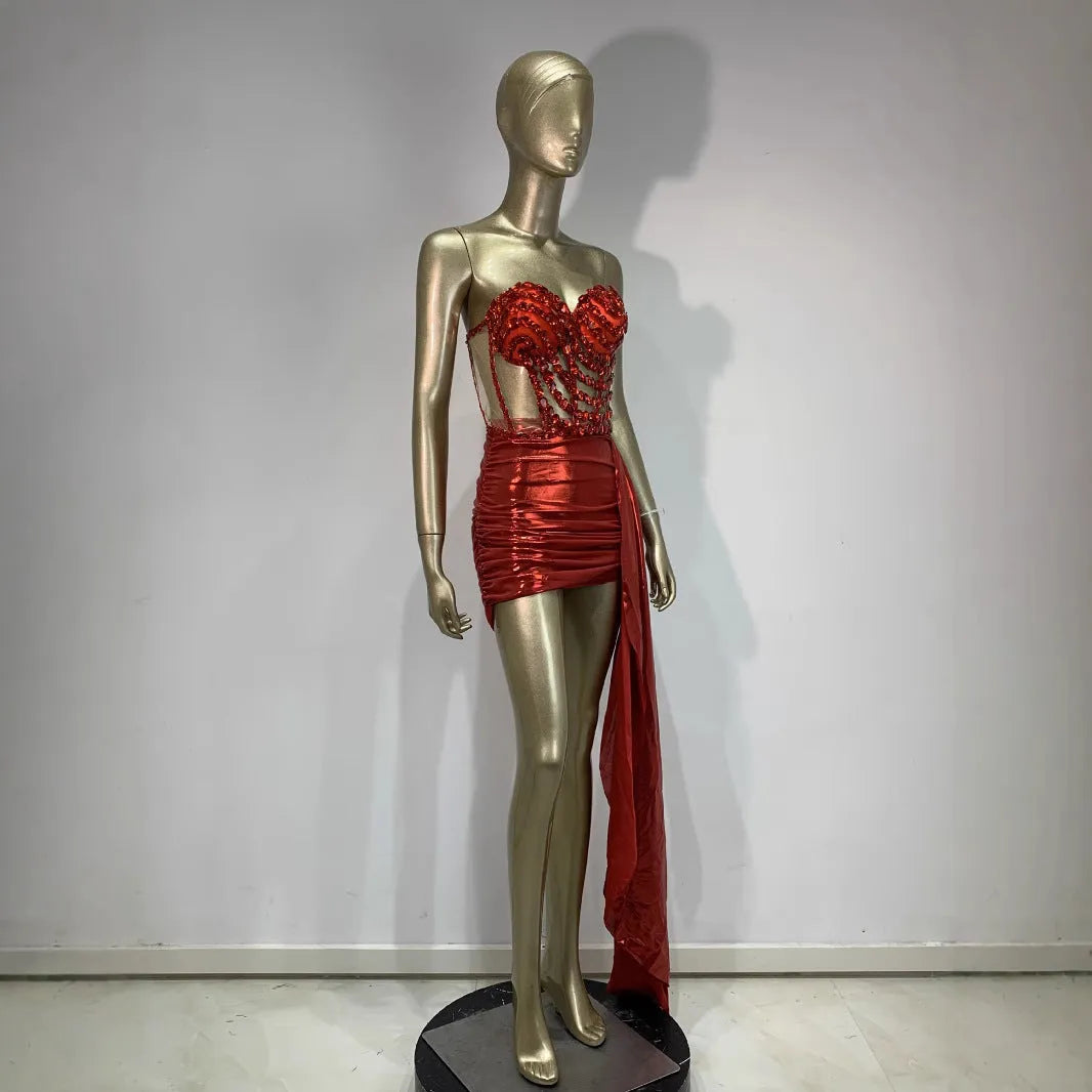 Red two-piece stage costume skirt suit with see-through mesh panels and a form-fitting spandex design.