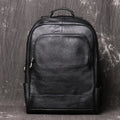 Men's black first layer cowhide leather travel backpack with multiple zipper pockets and top handles, 30cm by 42cm.