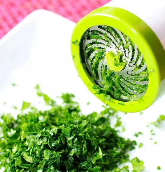 White plastic herb grinder mill with stainless steel blades and ergonomic handle for chopping fresh herbs