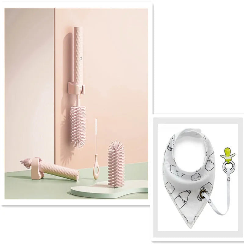 Pink and green electric rotating bottle cleaning brush with silicone bristles on a white background.