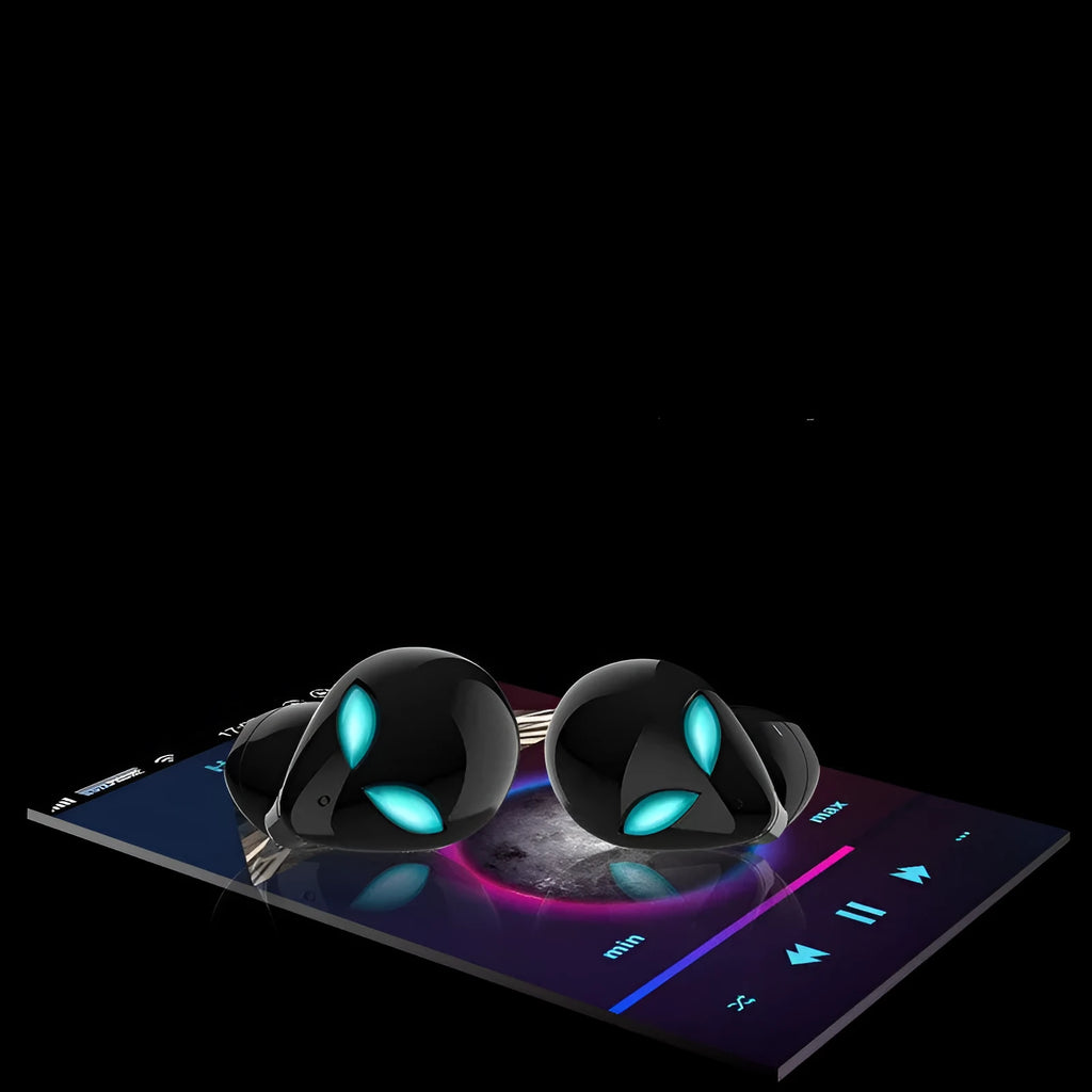 Creative Outer T8 Starman alien-shaped Bluetooth earbuds with LED lights next to their wireless charging case.
