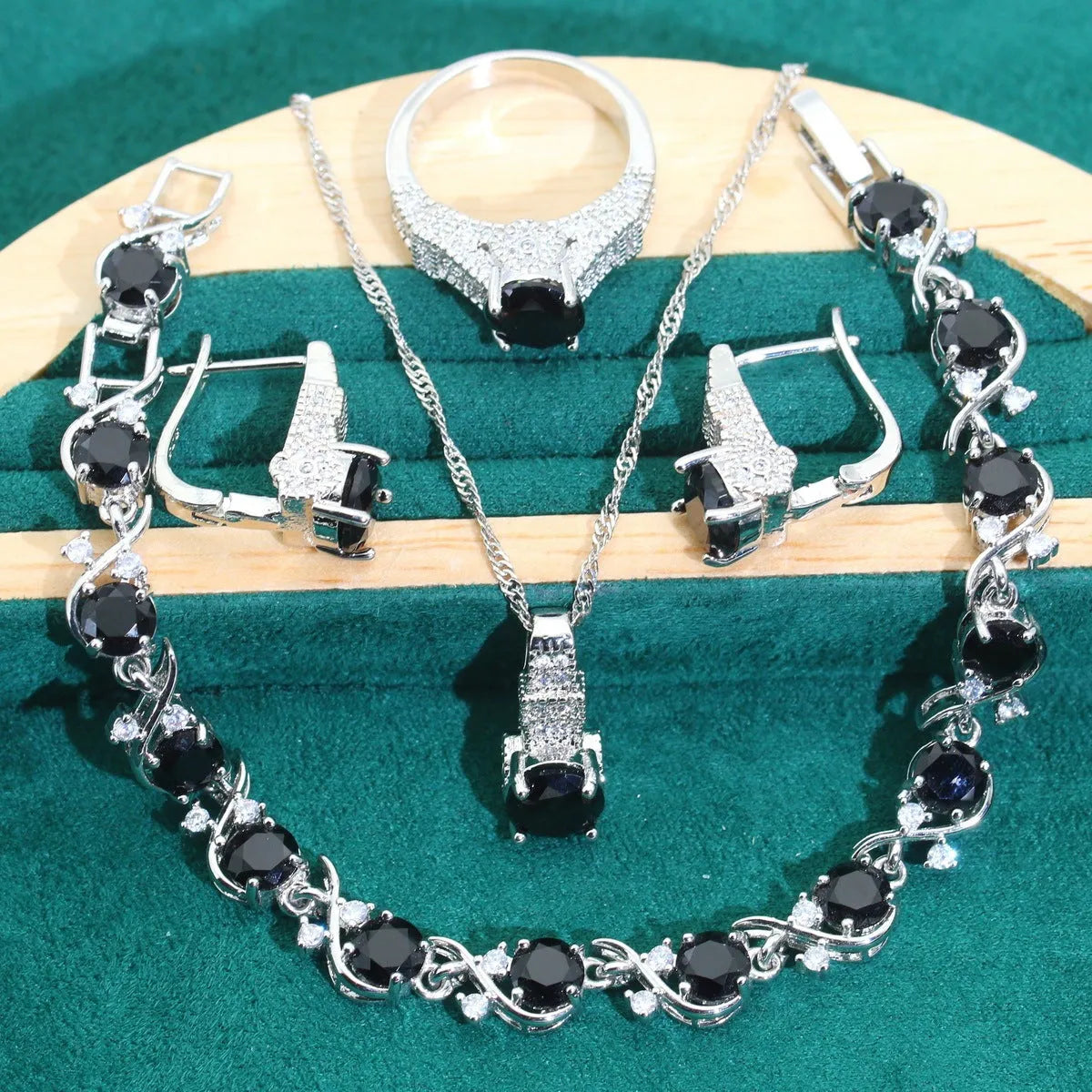 Bridal four-piece zircon jewellery set with necklace, bracelet, earrings and ring in water wave chain design.