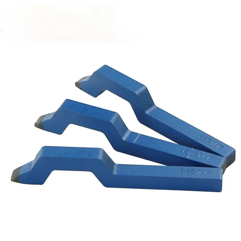 Curved character steel stamping tool for jewellery making on a workbench.