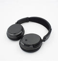 Black wireless stereo headset with USB FM transmitter and audio cable for wired use.