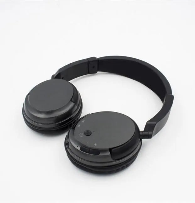 Black wireless stereo headset with USB FM transmitter and audio cable for wired use.