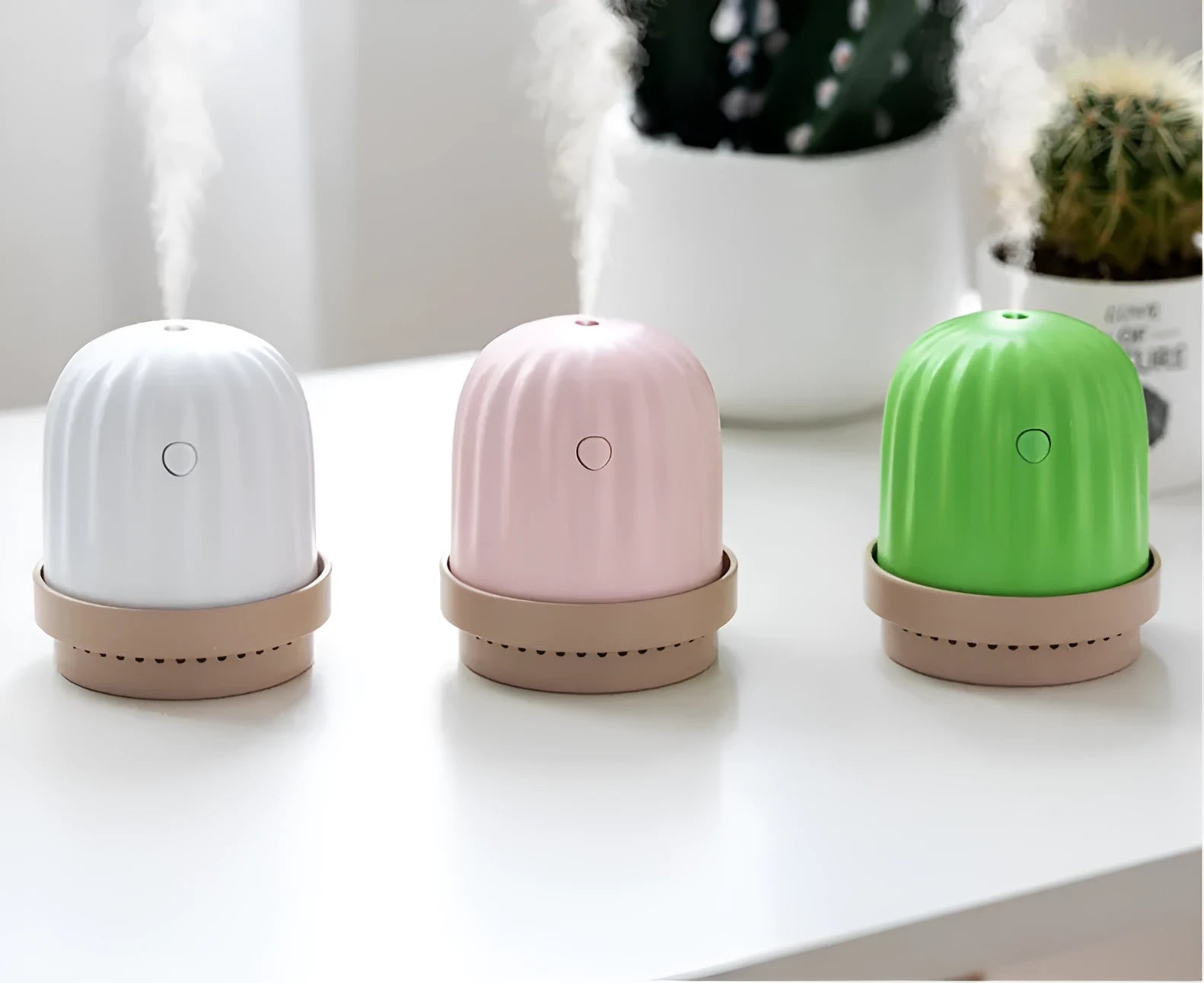 Cactus humidifier night light in green with colourful LED glow on a wooden desk