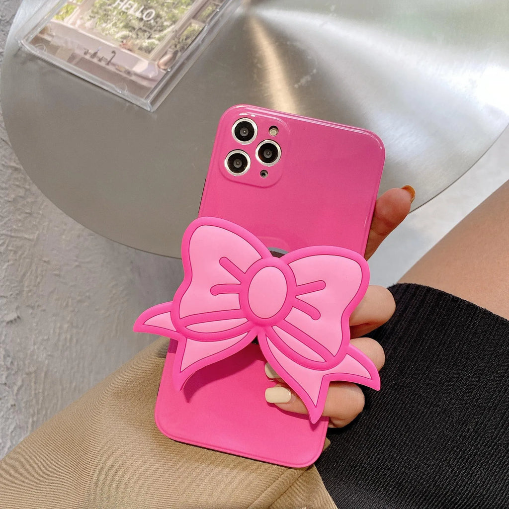 Rose red iPhone case with a pink bow design and a fold-out kickstand on the back.