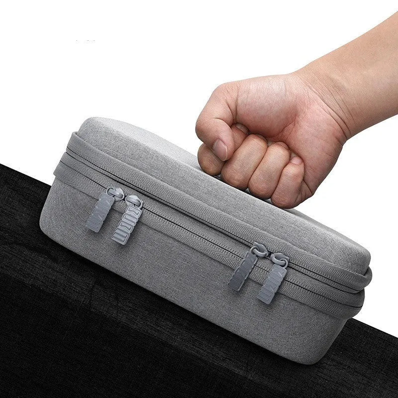 Black and grey EVA digital storage bag with hand bag shape for organising headphones and cables.