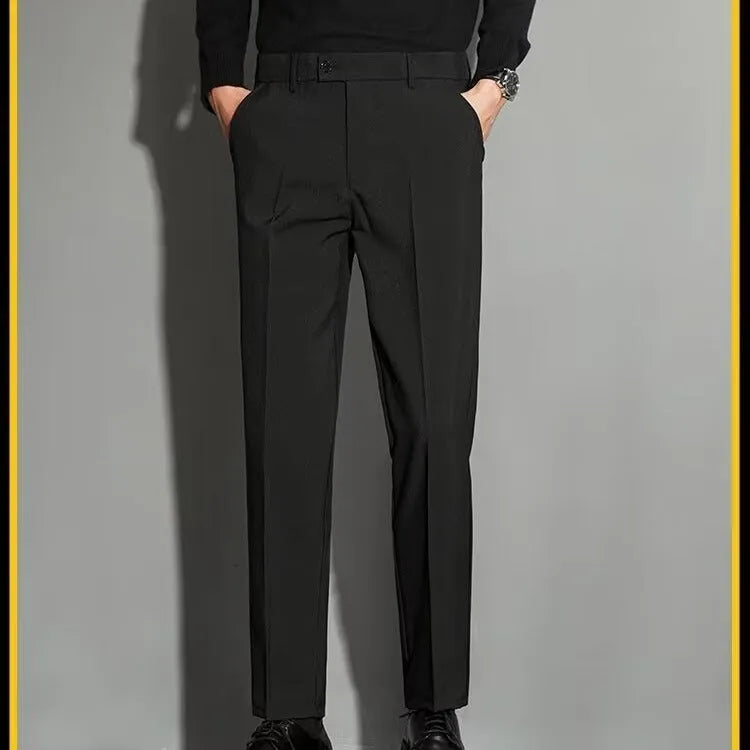 Men's straight-leg ankle-length suit trousers in a light colour, showing the spring draping effect on the leg.