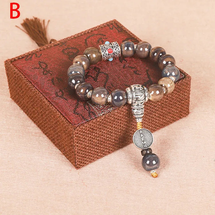 Men's gradient ceramic Yonghe blessing bracelet with coloured glaze beads on a wrist.