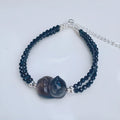 Cold obsidian climbing cat bracelet with hand-carved design and adjustable clasp
