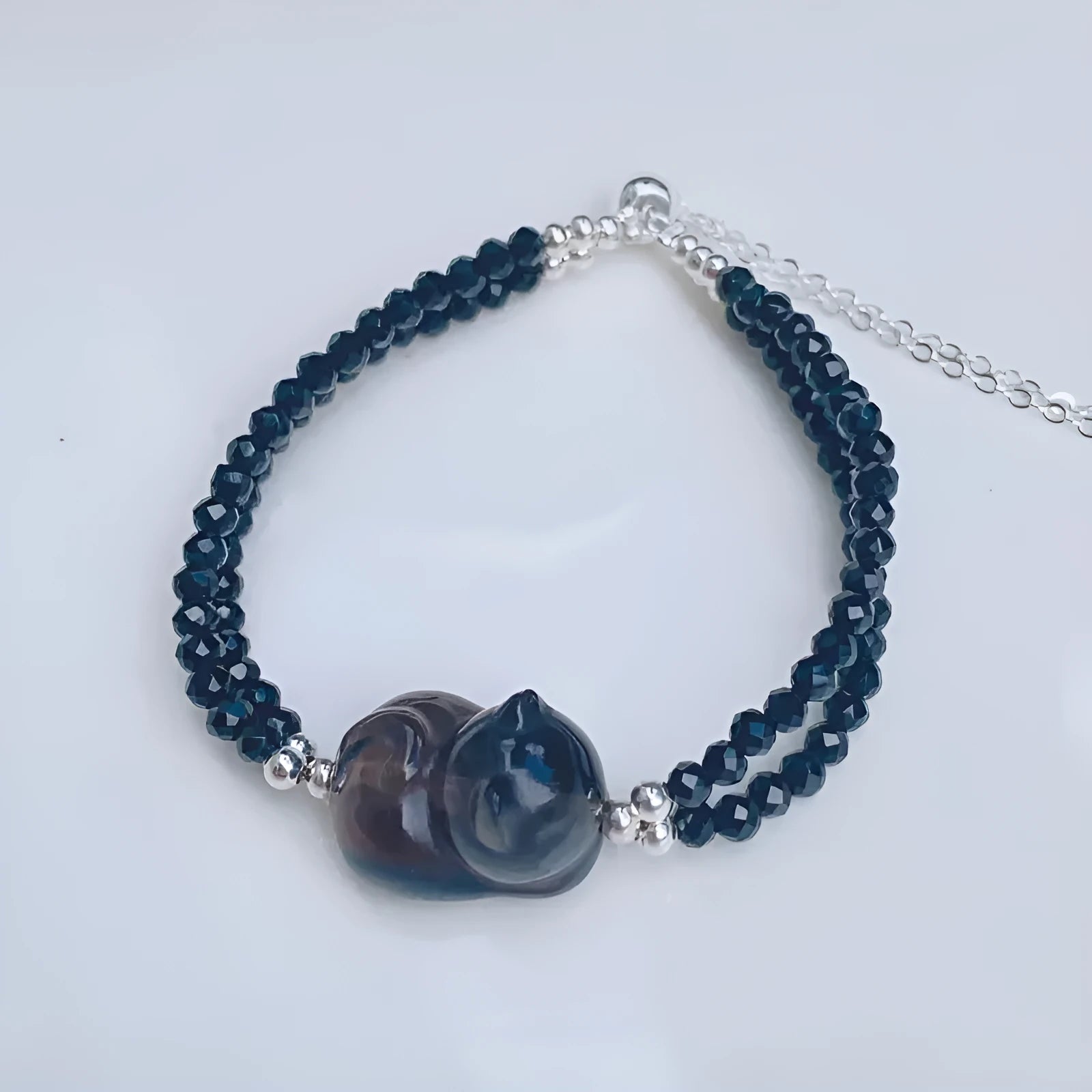 Cold obsidian climbing cat bracelet with hand-carved design and adjustable clasp