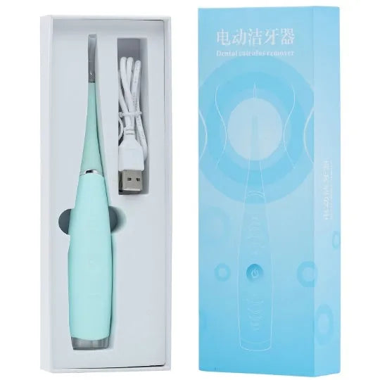 Pink and blue waterproof electric dental scaler tool on a bathroom counter with charging cable.