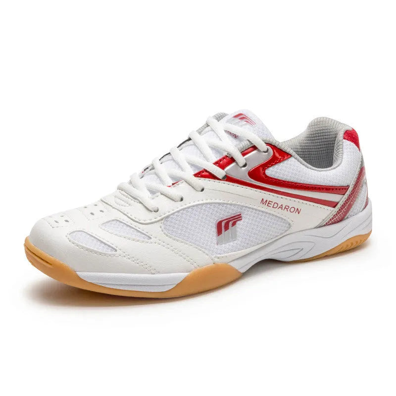 White table tennis sneakers with red accents, showing mesh panels, lace-up front, and rubber outsole.