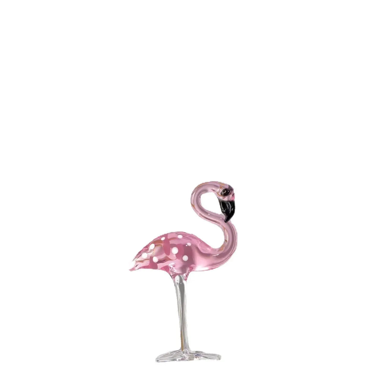 Pink flamingo decorative ornament made of white crystal on a table.