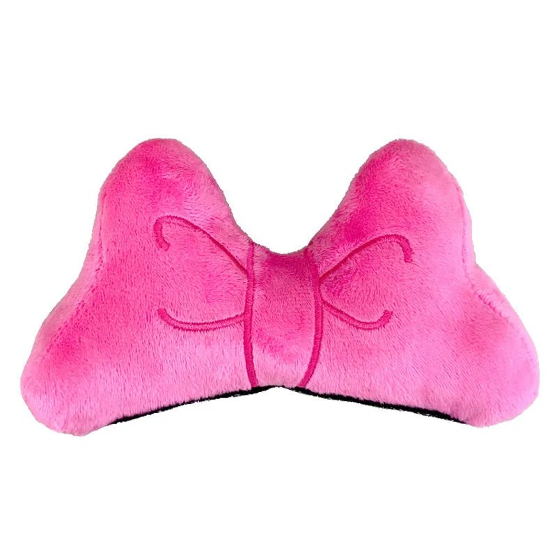Soft plush bow tie decoration for helmets in red, peach pink, and rose pink on a motorcycle helmet.