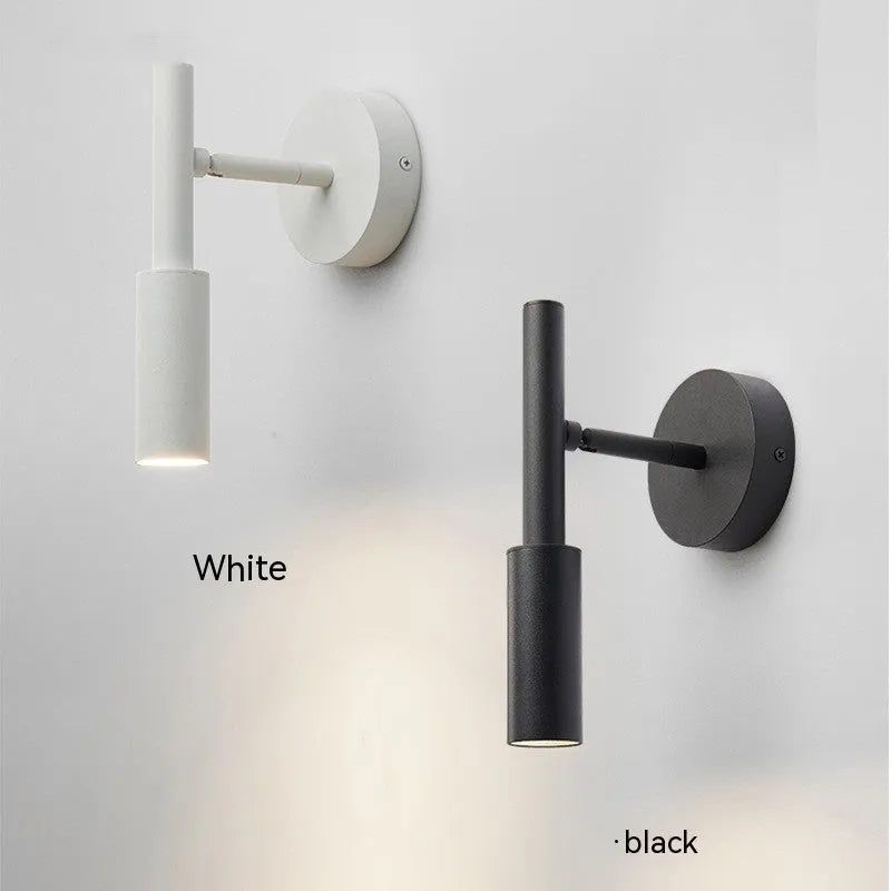 Black and white modern wrought iron wall lamp with a compact shade.