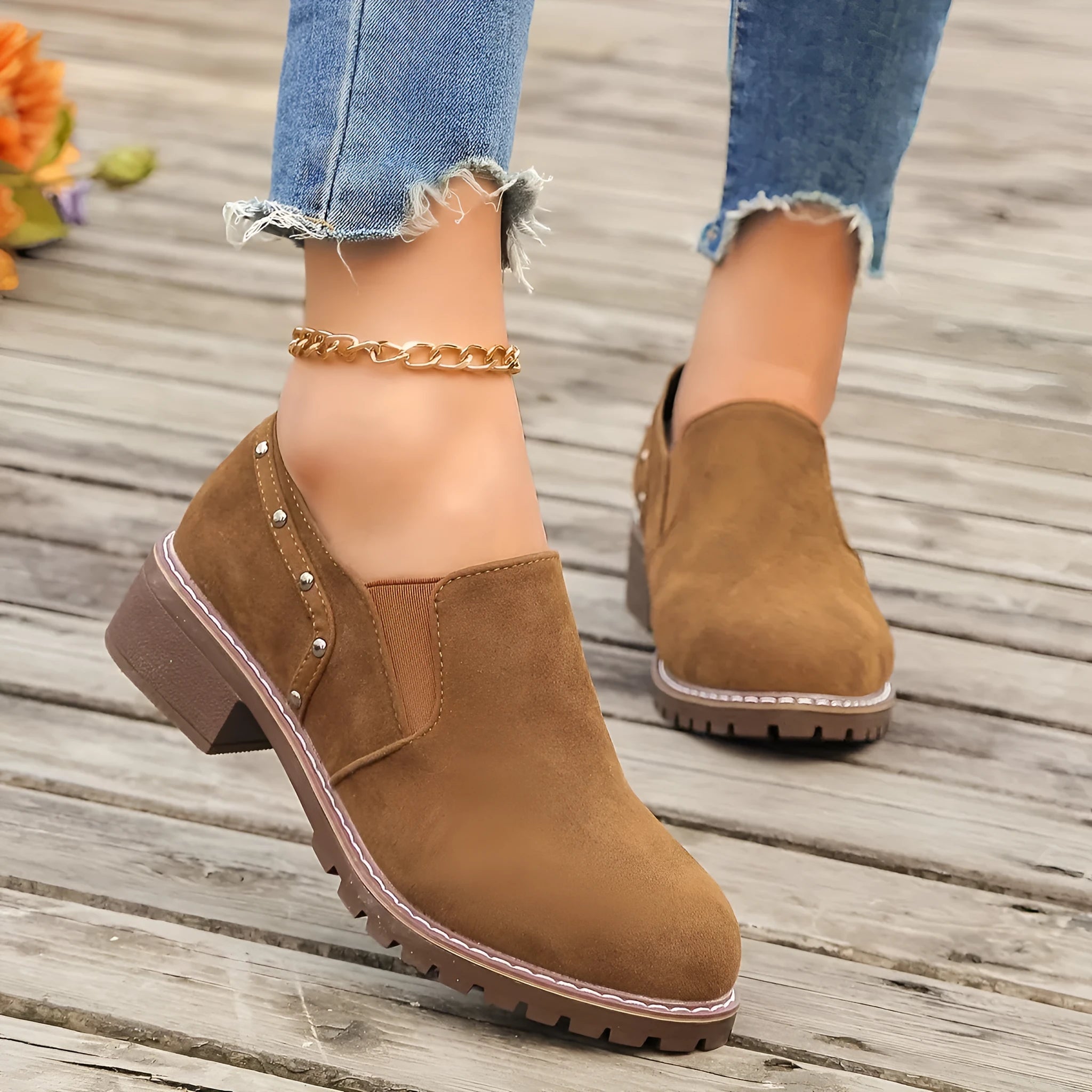 Women's light brown suede ankle boots with a low block heel and elasticated ankle cuff.