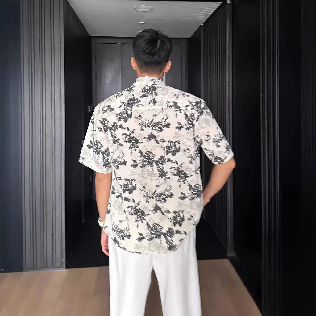 Women's loose-fit floral print short sleeve shirt in white, shown with a cardigan-style button front.