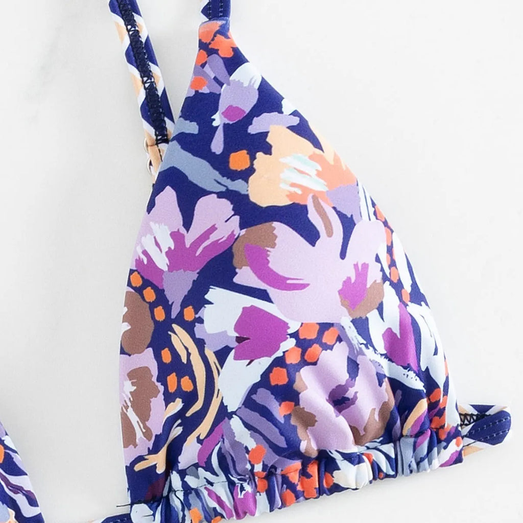 Women's floral print triangle top bikini swimsuit with briefs style bottoms in polyester fabric.