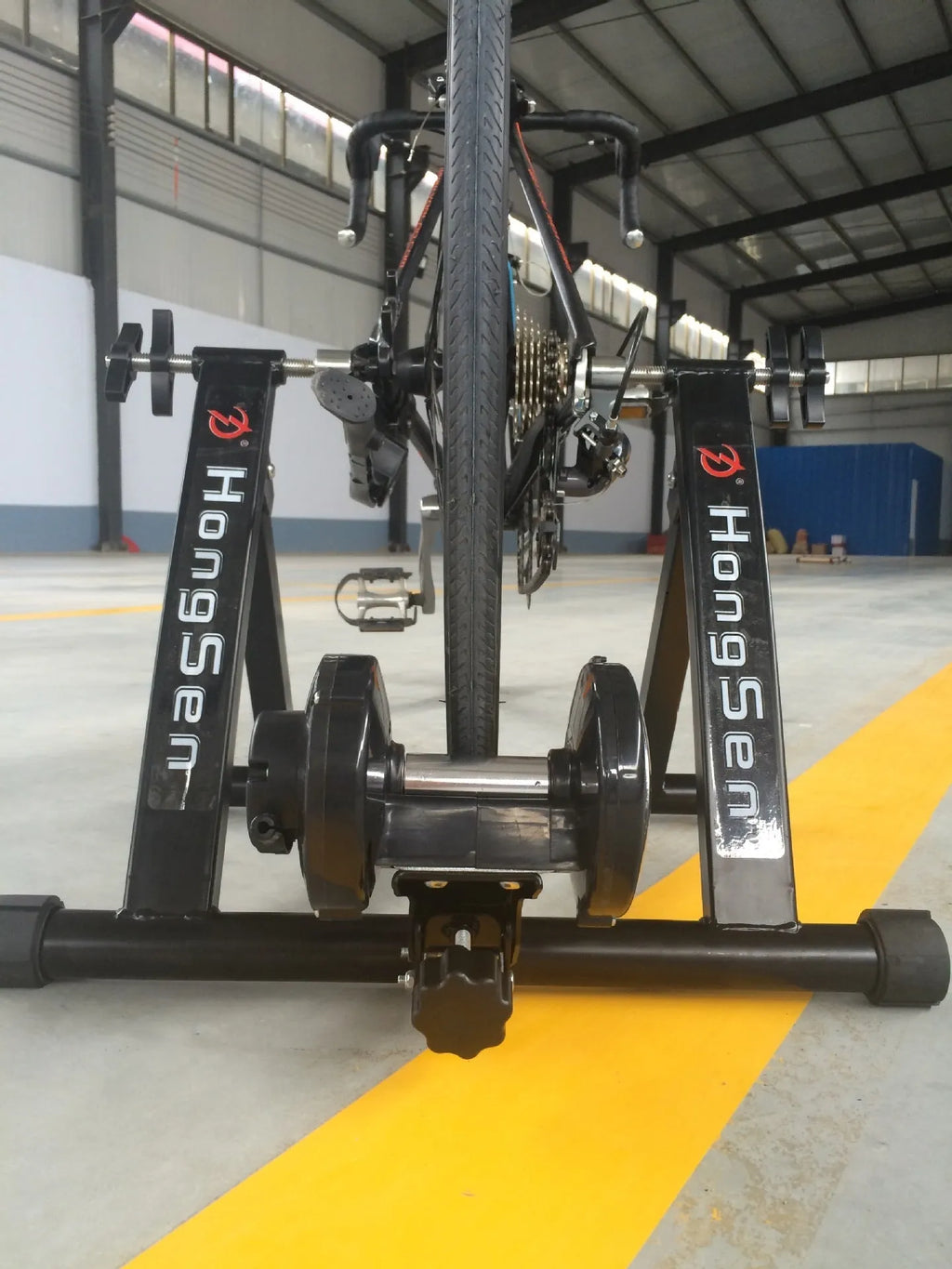Indoor cycling training platform with magnetoresistance line control and fixed parking frame for 66-69cm bikes, black